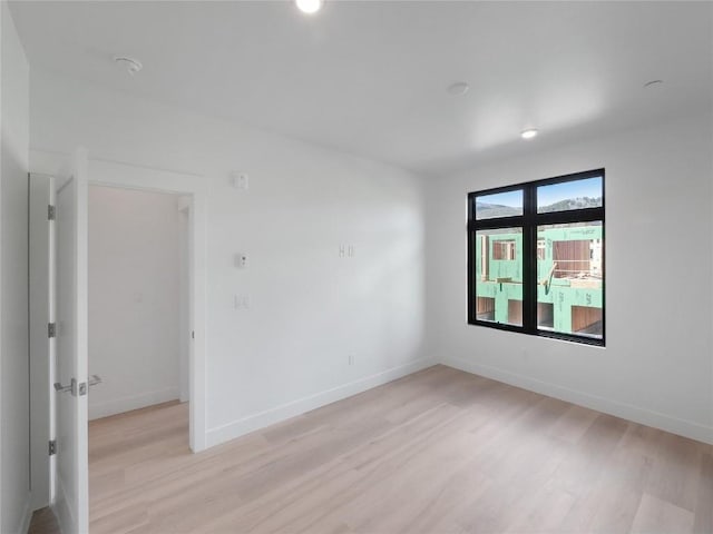 740 Blue River Pkwy Unit A22, Silverthorne, CO 80498 - unfurnished room featuring light wood-style floors, baseboards, and recessed lighting