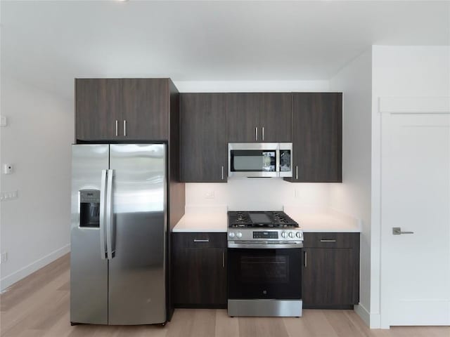 740 Blue River Pkwy Unit A22, Silverthorne, CO 80498 - kitchen with stainless steel appliances, light countertops, and light wood-type flooring