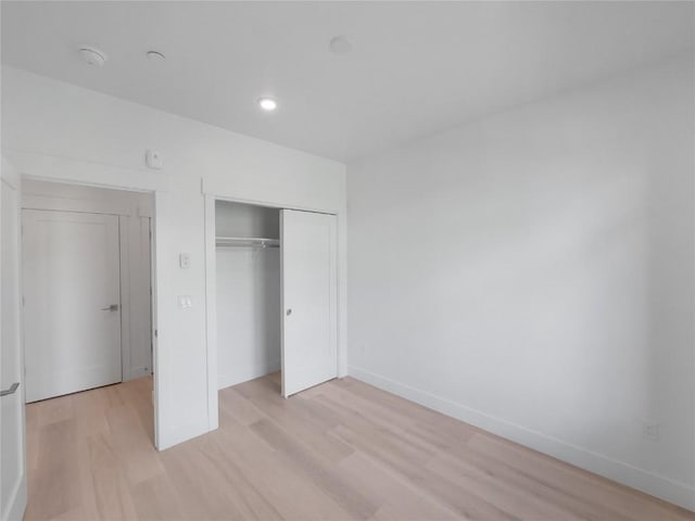 740 Blue River Pkwy Unit A22, Silverthorne, CO 80498 - unfurnished bedroom with light wood-style floors, baseboards, a closet, and recessed lighting