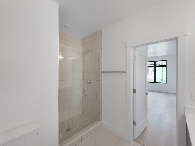 740 Blue River Pkwy Unit A22, Silverthorne, CO 80498 - bathroom with a shower stall, toilet, tile patterned floors, and baseboards