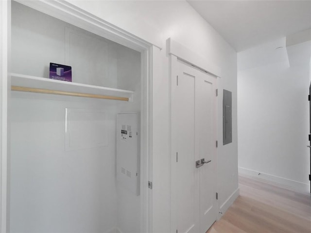 740 Blue River Pkwy Unit A22, Silverthorne, CO 80498 - corridor featuring light wood finished floors, baseboards, and electric panel