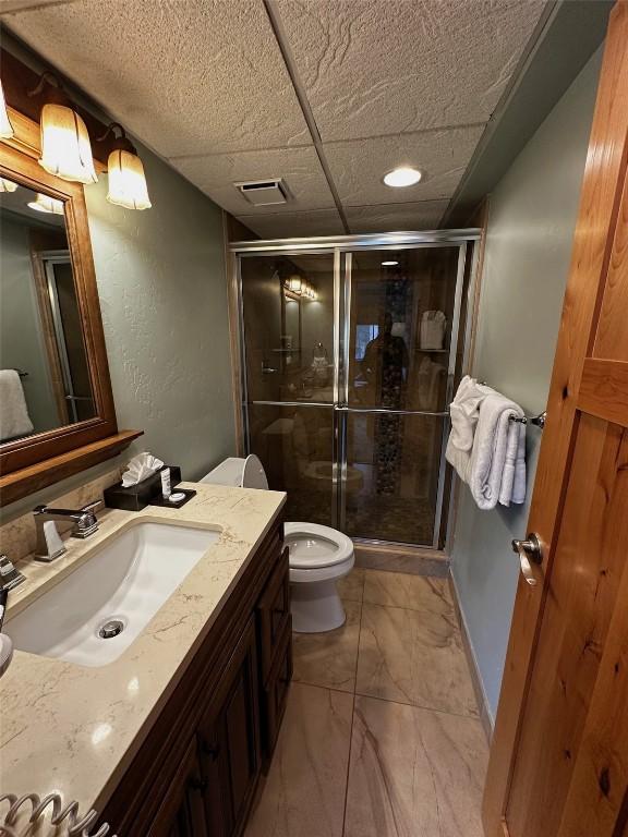 601 Village Rd # 501, Breckenridge, CO 80424 - full bath with marble finish floor, visible vents, toilet, vanity, and a stall shower