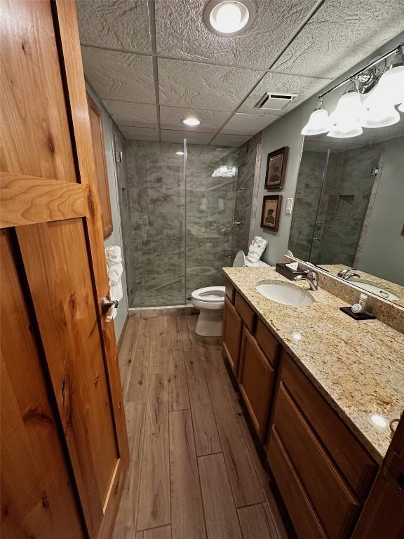 601 Village Rd # 501, Breckenridge, CO 80424 - full bath with a shower stall, hardwood / wood-style floors, visible vents, toilet, and vanity