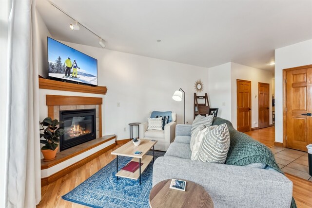 850 Blue River Pkwy Unit E5, Silverthorne, CO 80498 - living area with a glass covered fireplace, track lighting, and wood finished floors