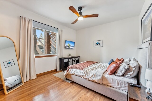 850 Blue River Pkwy Unit E5, Silverthorne, CO 80498 - bedroom with light wood-style floors, baseboards, and a ceiling fan