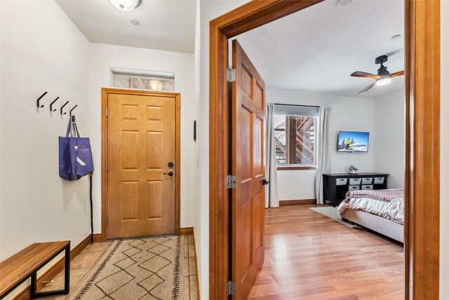 850 Blue River Pkwy Unit E5, Silverthorne, CO 80498 - foyer with a ceiling fan, baseboards, and light wood finished floors