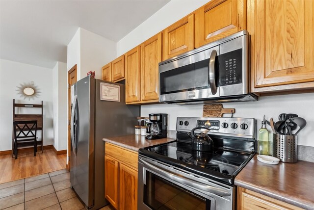 850 Blue River Pkwy Unit E5, Silverthorne, CO 80498 - kitchen featuring stainless steel appliances and light tile patterned floors