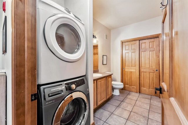 850 Blue River Pkwy Unit E5, Silverthorne, CO 80498 - bathroom with vanity, tile patterned flooring, visible vents, toilet, and stacked washer / drying machine