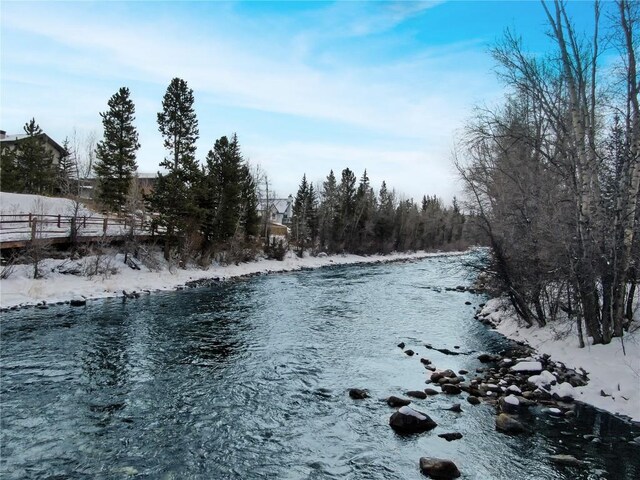 850 Blue River Pkwy Unit E5, Silverthorne, CO 80498 - snowy yard featuring a water view