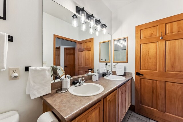 850 Blue River Pkwy Unit E5, Silverthorne, CO 80498 - bathroom with a sink, tile patterned flooring, toilet, and double vanity