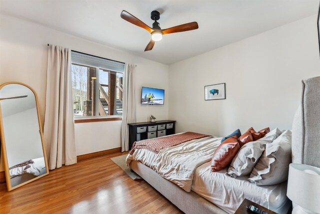 850 Blue River Pkwy Unit E5, Silverthorne, CO 80498 - bedroom featuring baseboards, a ceiling fan, and light wood finished floors