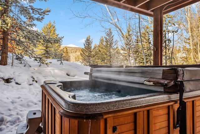 exterior space with a mountain view and a hot tub