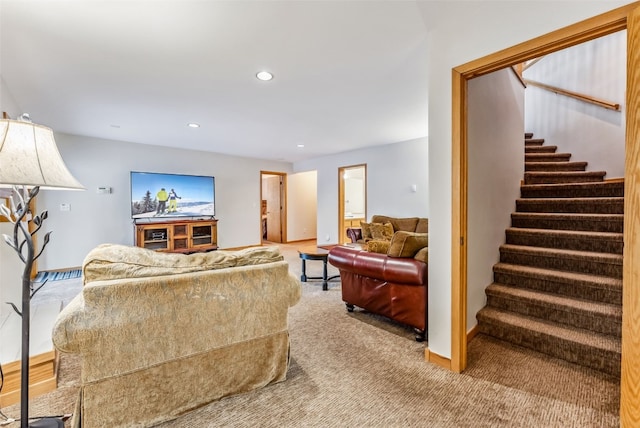 carpeted living area featuring stairway, baseboards, and recessed lighting