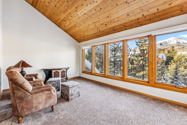 living area with a mountain view, baseboards, carpet, lofted ceiling, and wood ceiling