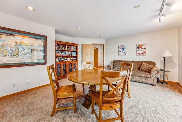 dining room featuring baseboards, carpet flooring, recessed lighting, and rail lighting