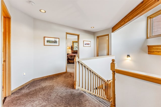 hallway with baseboards, carpet flooring, an upstairs landing, and recessed lighting
