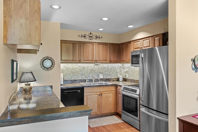 1675 Ranch Rd Unit 410, Steamboat Springs, CO 80487 - kitchen with stainless steel appliances, a sink, dark countertops, backsplash, and recessed lighting