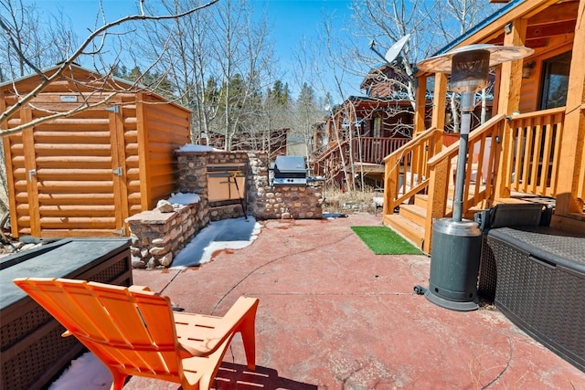 view of patio / terrace featuring an outdoor kitchen and a grill