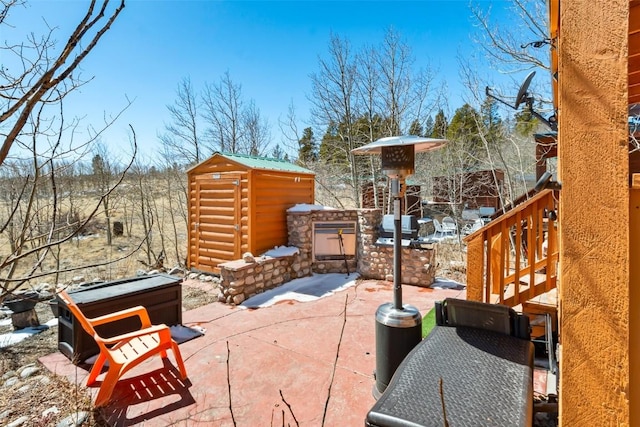view of patio / terrace featuring a storage unit and an outbuilding