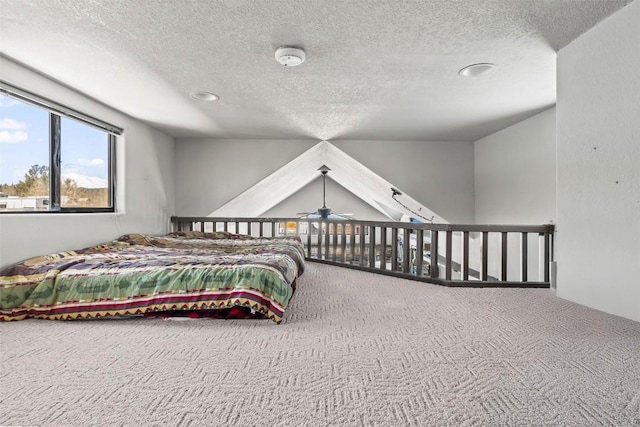 carpeted bedroom featuring a textured ceiling