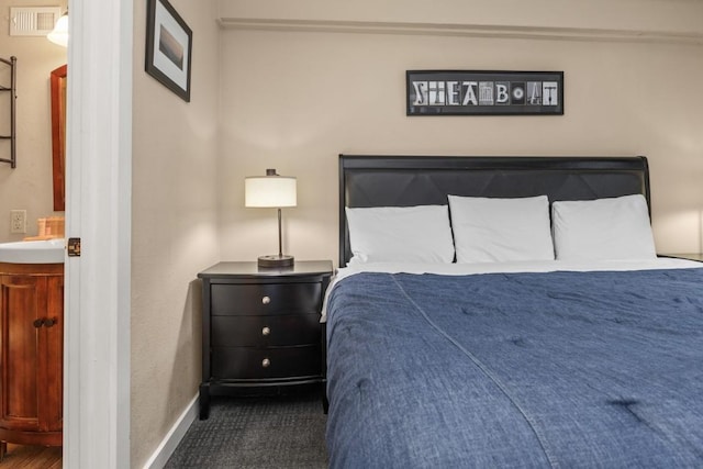 2626 Longthong Rd Unit 203, Steamboat Springs, CO 80487 - bedroom featuring ensuite bathroom, visible vents, and baseboards