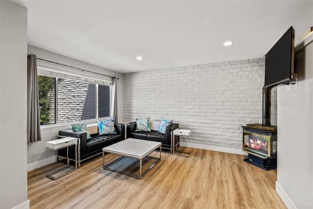 13 Cedar Ct Unit 13, Steamboat Springs, CO 80487 - living area with a wood stove, wood finished floors, recessed lighting, and brick wall