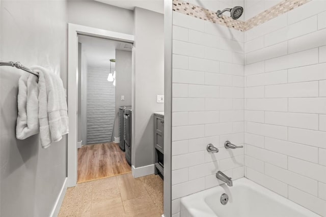 13 Cedar Ct Unit 13, Steamboat Springs, CO 80487 - full bathroom with washing machine and dryer, washtub / shower combination, and vanity