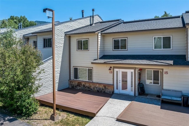 13 Cedar Ct Unit 13, Steamboat Springs, CO 80487 - back of house with a wooden deck, roof with shingles, and stone siding