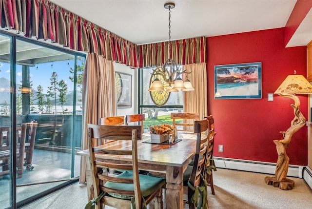 dining space featuring a baseboard radiator, a healthy amount of sunlight, and an inviting chandelier