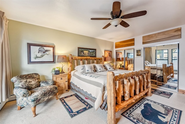 carpeted bedroom with two closets and a ceiling fan