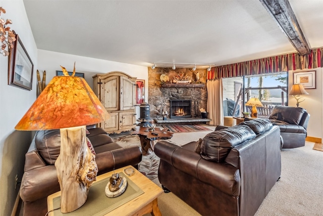 carpeted living room featuring a fireplace and track lighting