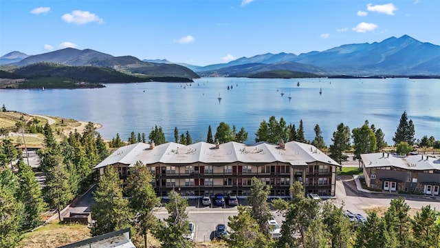 birds eye view of property featuring a water and mountain view