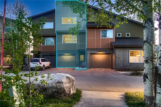 835 Weiss Cir Unit 2, Steamboat Springs, CO 80487 - view of front facade featuring a garage, driveway, and roof with shingles