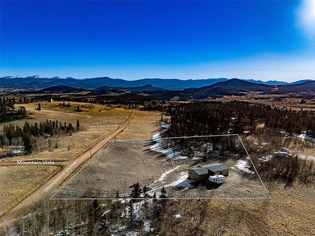 drone / aerial view featuring a mountain view and a rural view