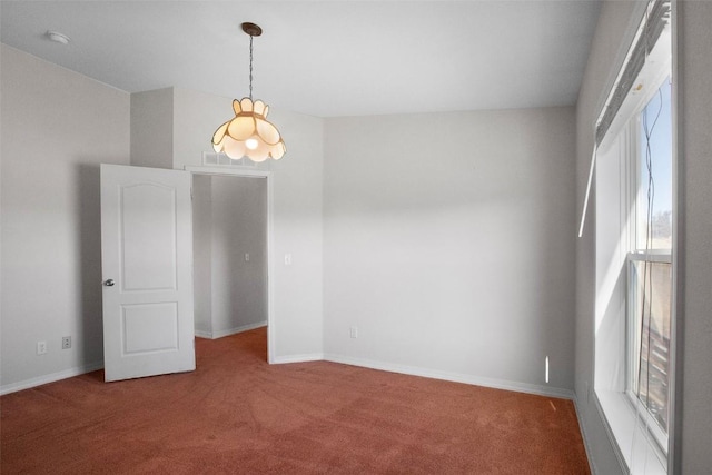 carpeted empty room with baseboards and a wealth of natural light