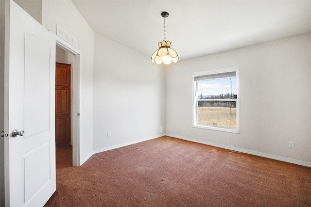 carpeted spare room with visible vents, baseboards, and a notable chandelier