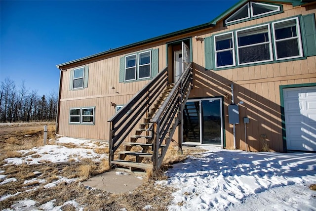 snow covered house with stairs