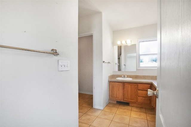 bathroom with vanity, tile patterned flooring, baseboards, and visible vents