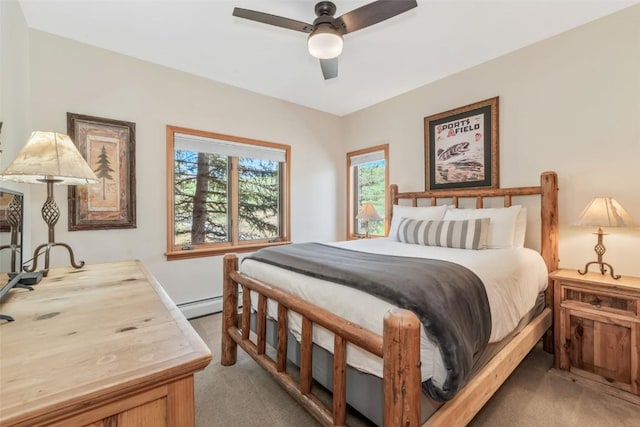 bedroom featuring ceiling fan, a baseboard heating unit, and light colored carpet