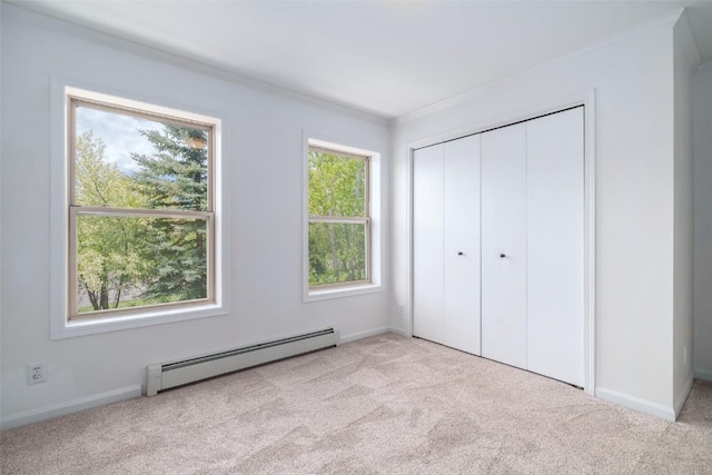 3100 Chinook Ln Unit 6, Steamboat Springs, CO 80487 - unfurnished bedroom featuring baseboard heating, carpet flooring, multiple windows, and ornamental molding