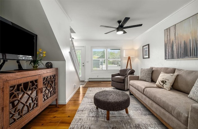 3100 Chinook Ln Unit 6, Steamboat Springs, CO 80487 - living area with a baseboard heating unit, wood finished floors, ornamental molding, ceiling fan, and baseboards