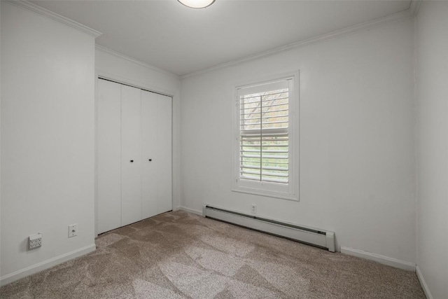 3100 Chinook Ln Unit 6, Steamboat Springs, CO 80487 - unfurnished bedroom with baseboard heating, carpet floors, crown molding, a closet, and baseboards