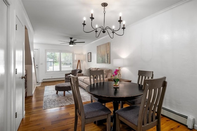 3100 Chinook Ln Unit 6, Steamboat Springs, CO 80487 - dining room featuring a ceiling fan, a baseboard radiator, a baseboard heating unit, wood finished floors, and crown molding