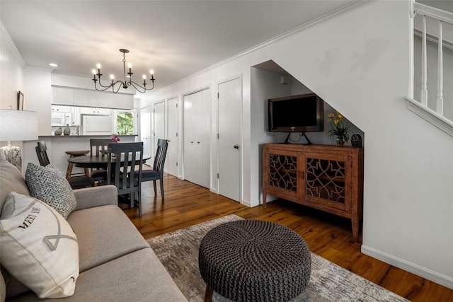 3100 Chinook Ln Unit 6, Steamboat Springs, CO 80487 - living area with crown molding, a chandelier, wood finished floors, and baseboards