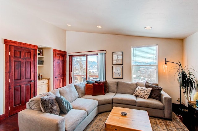living area featuring recessed lighting, lofted ceiling, wood finished floors, and plenty of natural light
