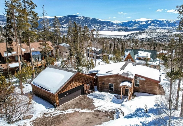 snowy aerial view with a mountain view