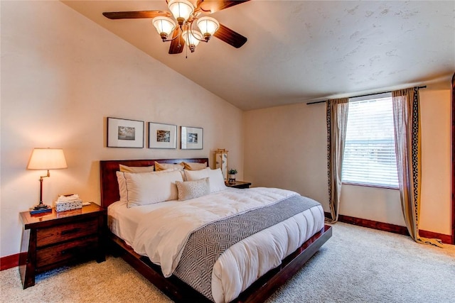 bedroom featuring lofted ceiling, light carpet, baseboards, and ceiling fan