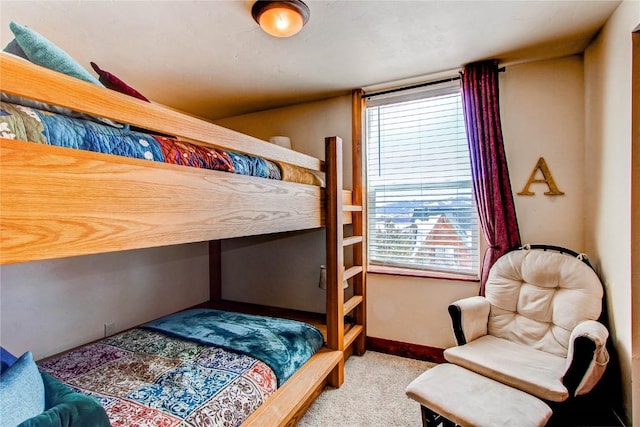 carpeted bedroom featuring baseboards