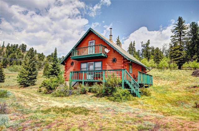 446 Chief Trl, Como, CO 80432 - view of front facade featuring log exterior, a balcony, and a deck