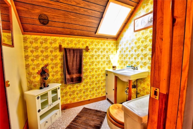 446 Chief Trl, Como, CO 80432 - half bath featuring wallpapered walls, a sink, vaulted ceiling, baseboards, and wood ceiling